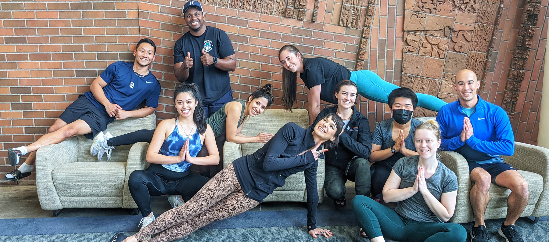 Students doing yoga poses in the atrium 