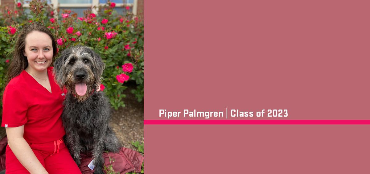 Piper Palmgren and pet dog pose in front of a blooming rose bush. 