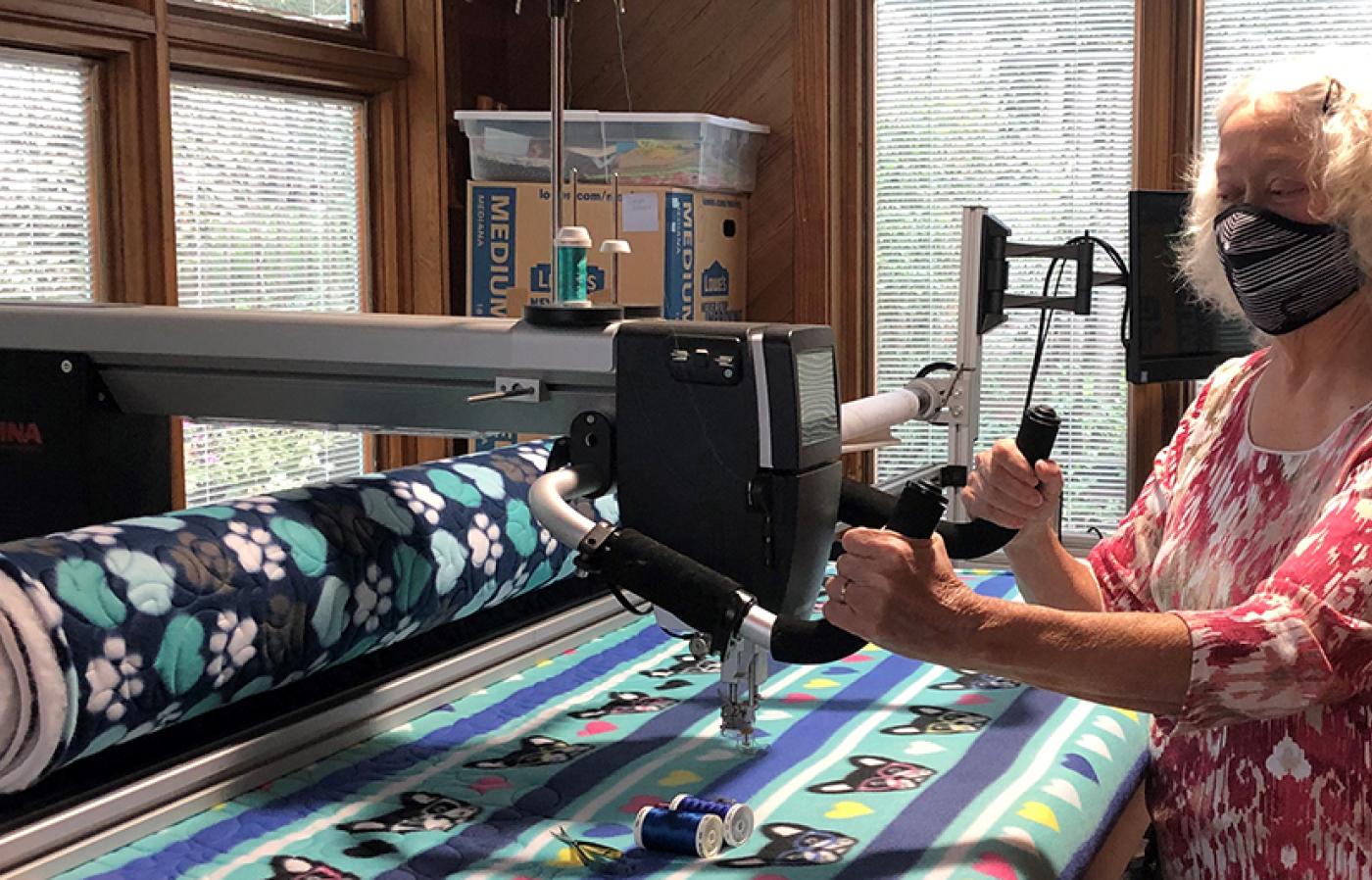 Diane Ostergaard sews kennel blankets