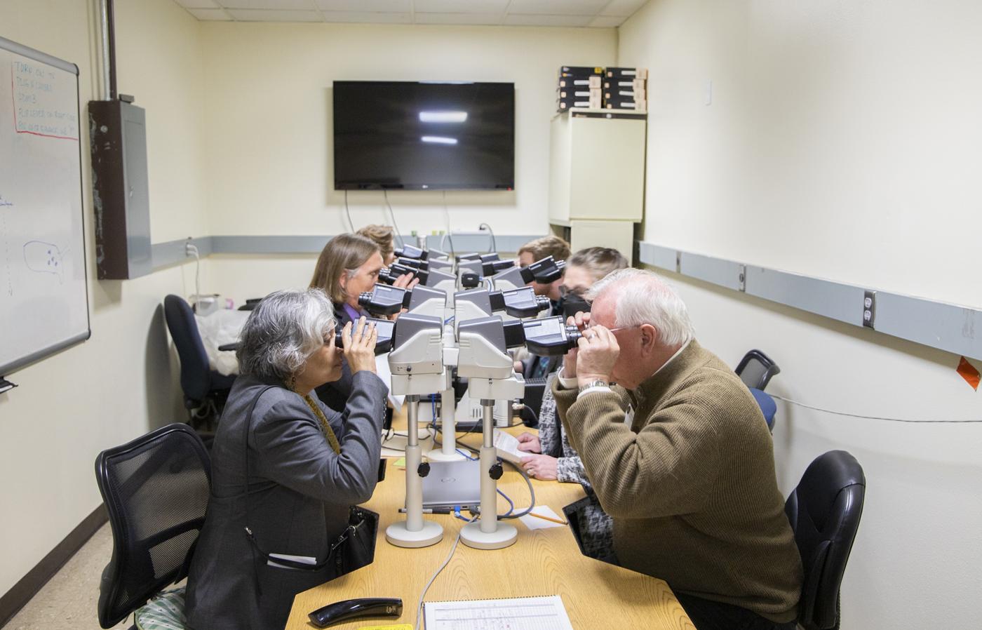 OVDL workers looking in microscopes