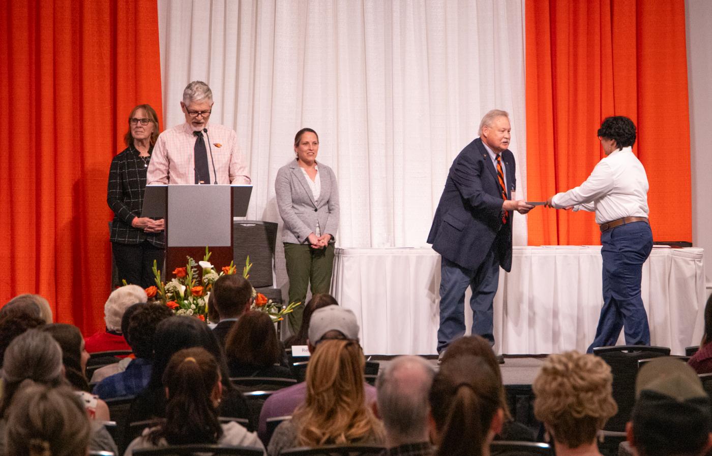 Dr. K presenting an award