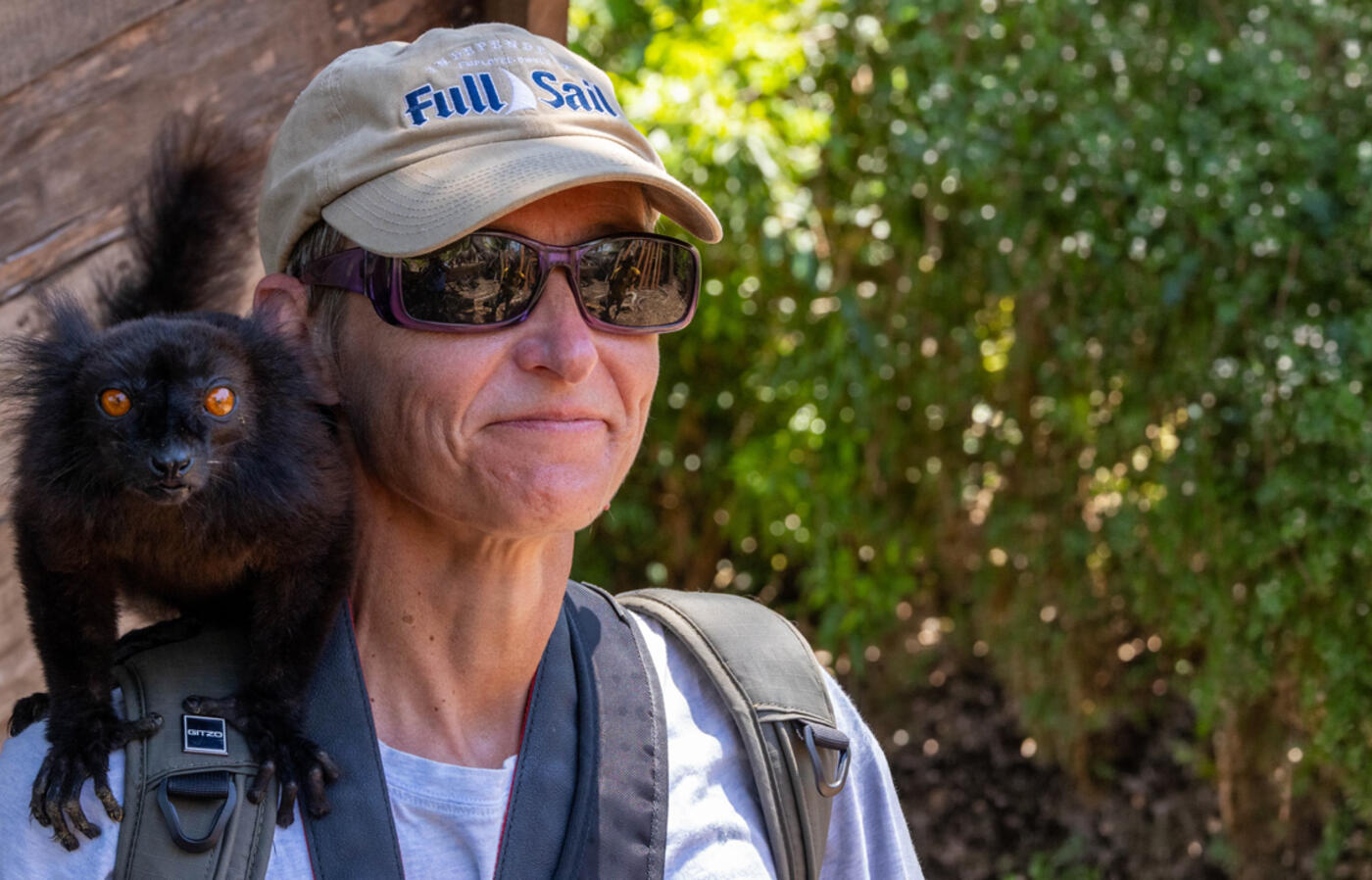 Dr. Löhr with a black lemur on her shoulder.