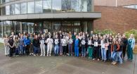 Group of veterinary students and staff hold up signs spelling out T H A N K Y OU ! 