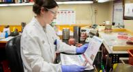 Sophia Ballard holds a chocolate agar plate in the bacteriology lab