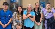 Donna Mulrooney, Wyatt the kitten and the veterinary care team pose for a photo.