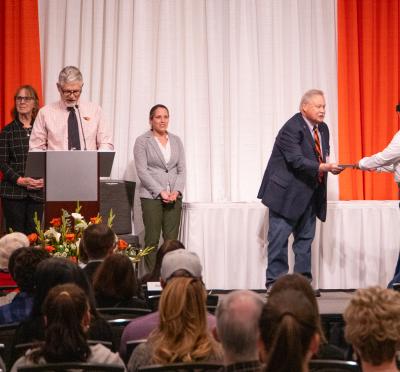 Dr. K presenting an award