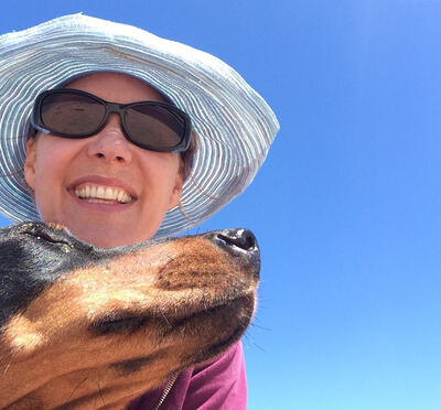 Woman in sunglasses on a sunny day with her dog