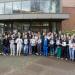 Group of veterinary students and staff hold up signs spelling out T H A N K Y OU ! 
