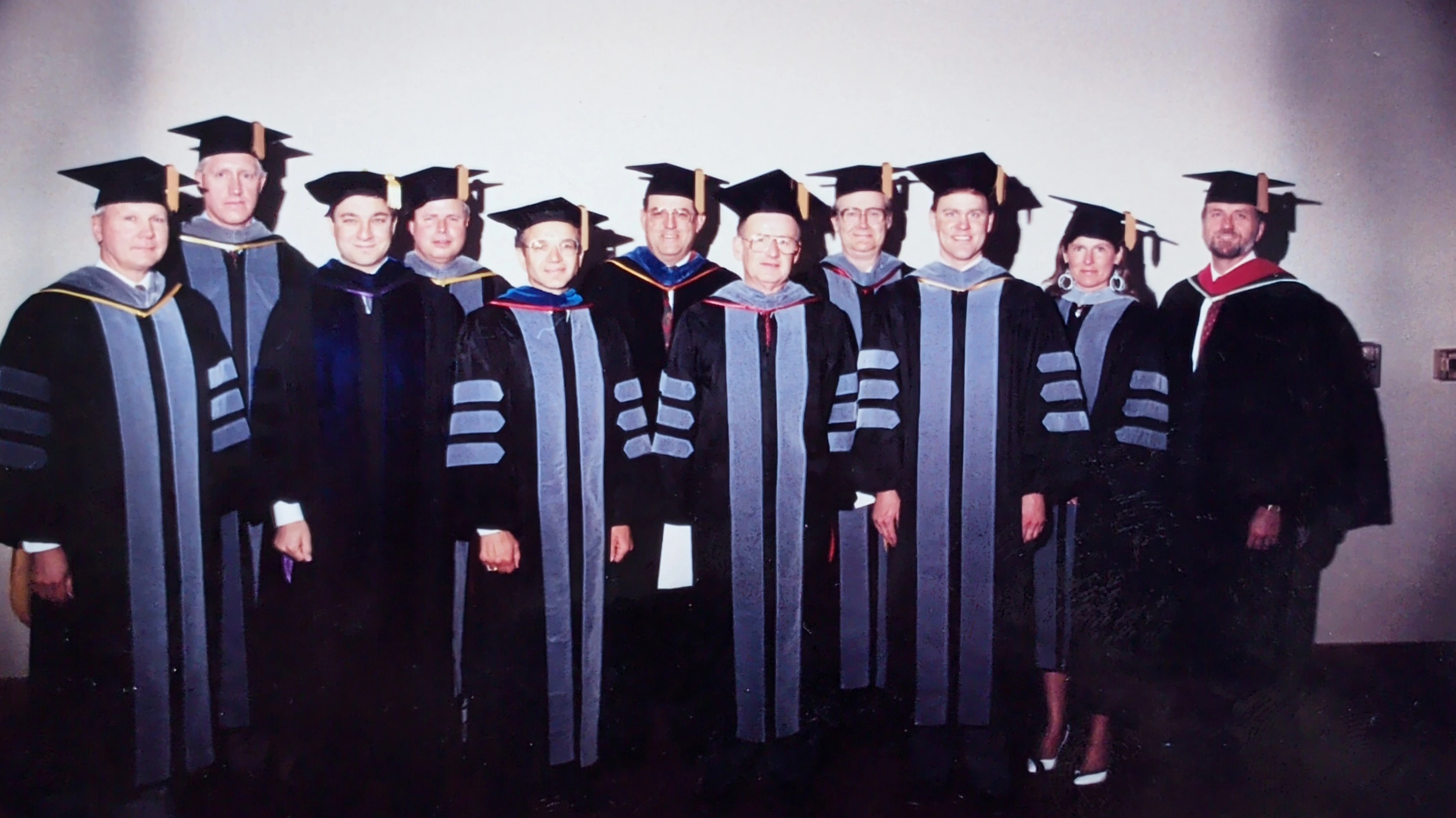 Group of faculty members in graduation regalia. 