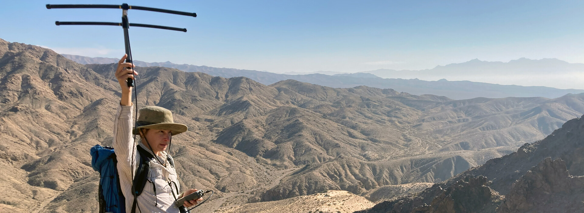 Anna Jolles holds an antenna in the Mojave desert to track bighorn sheep.