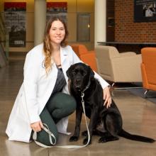 Kayla Neiderfer with her black puppy