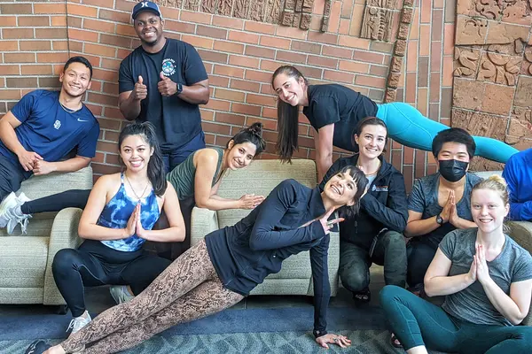 Students doing yoga poses in the atrium 