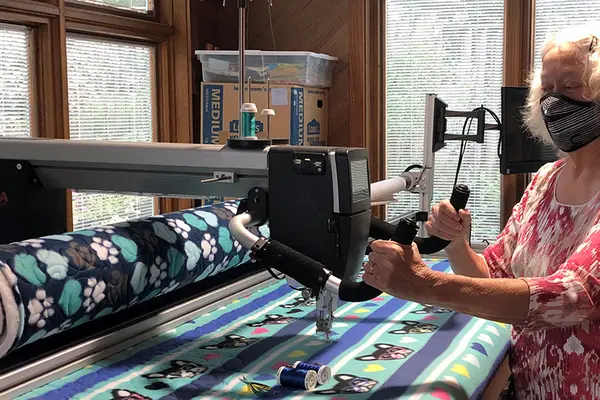 Diane Ostergaard sews kennel blankets