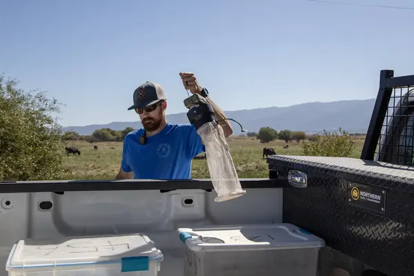 Matt Hutchinson prepares to set mosquito traps in the Baker Valley