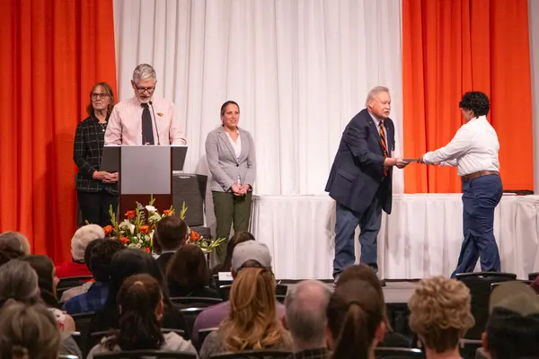 Dr. K presenting an award