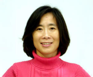 woman smiling in pink shirt