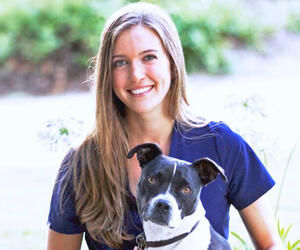 Woman smiling with a dog
