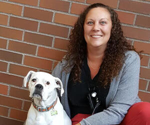 Woman smiling with a dog
