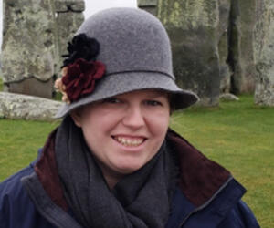 Woman smiling in front of Stonehenge