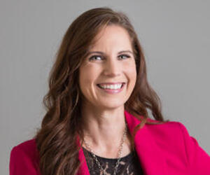 Portrait of person with gray background.