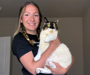 Woman holds cat. 