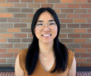 Dr. Kim portrait with brick background