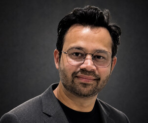 Portrait of man with gray background.
