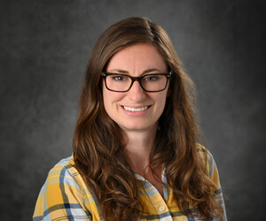 Portrait of person with gray background. 